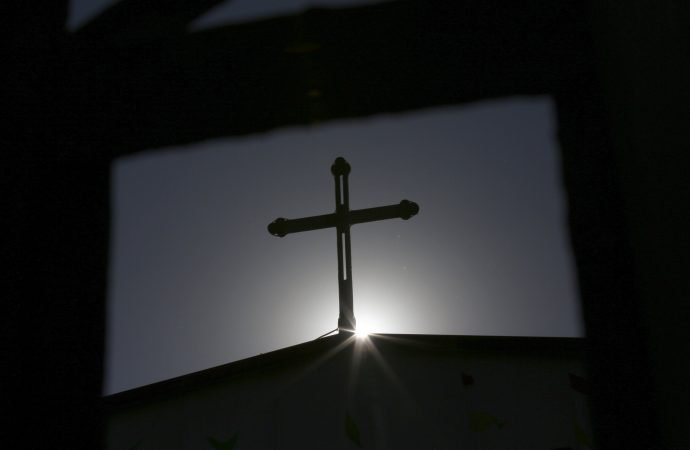 A cross atop a Catholic church in Tianjin, China, is seen silhouetted against the sun. (Kim Kyung-Hoon/Reuters via CNS)