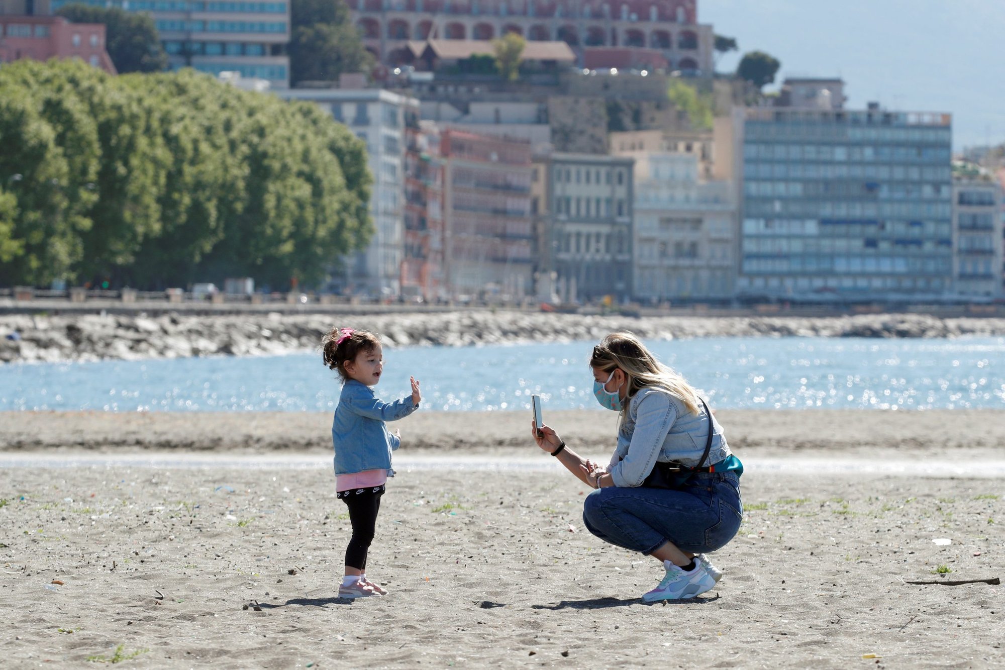A woman and a child are seen at the beach in Naples, Italy, in this May 4, 2020, file photo. Pope Francis is scheduled to open a May 14 meeting discussing the challenges posed by Italy's low birth rate. (CNS photo/Ciro De Luca, Reuters)