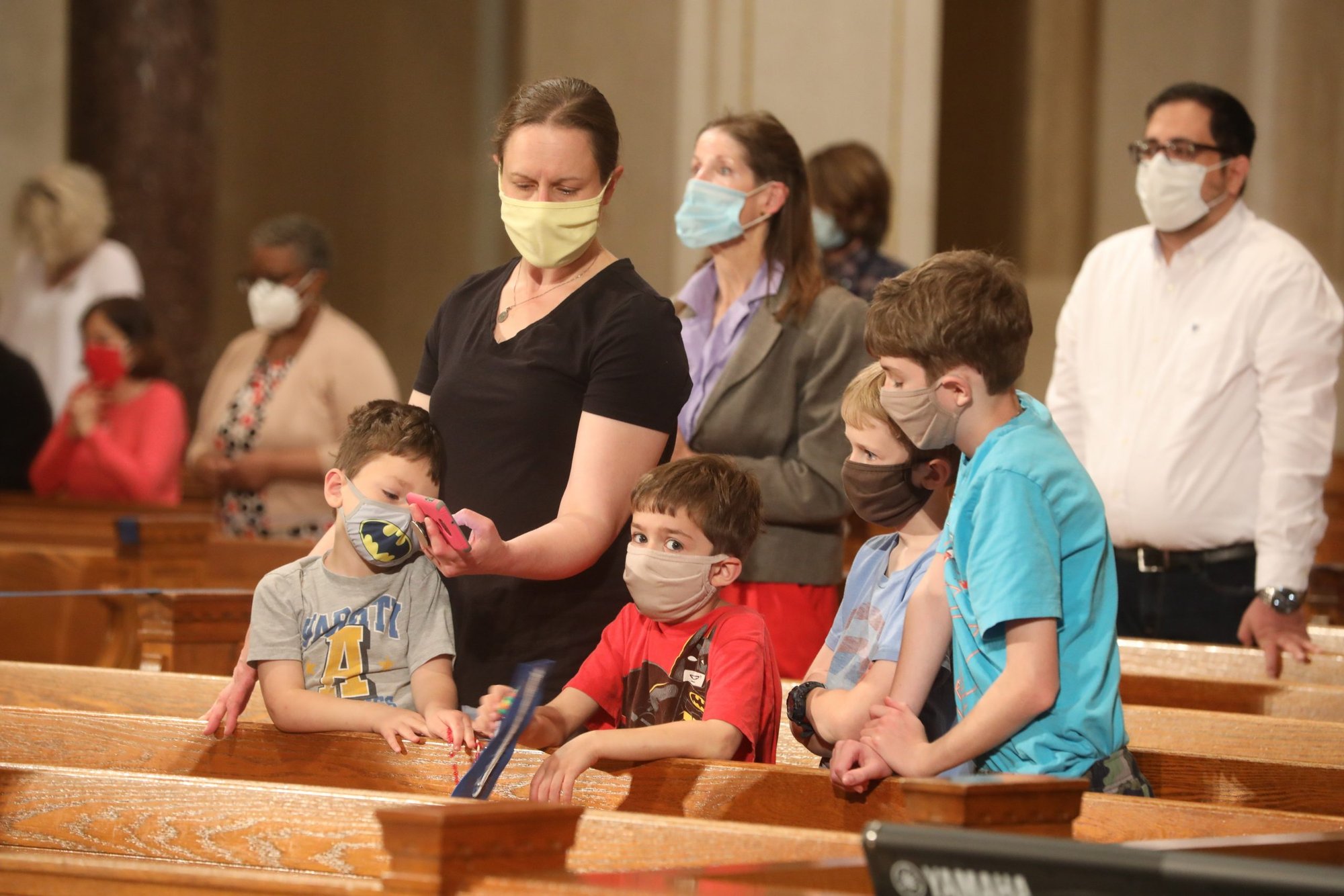 A family prays the rosary at the Basilica of the National Shrine of the Immaculate Conception in Washington May 17, 2021. The rosary, led by Washington Cardinal Wilton D. Gregory, was part of a worldwide effort called by Pope Francis to pray for an end to the coronavirus pandemic. (CNS photo/Andrew Biraj, Catholic Standard)