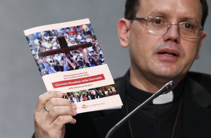 Father João Chagas, head of the Youth Office at the Dicastery for Laity, the Family and Life, holds a Vatican document on World Youth Day as he speaks at a news conference at the Vatican May 18, 2021. Speakers discussed the release of a Vatican document with pastoral guidelines for the celebration of World Youth Day in local dioceses. The document emphasized the importance of the local celebration of World Youth Day as an annual "festival of faith" similar to the international celebration held every three years. (CNS photo/Paul Haring)