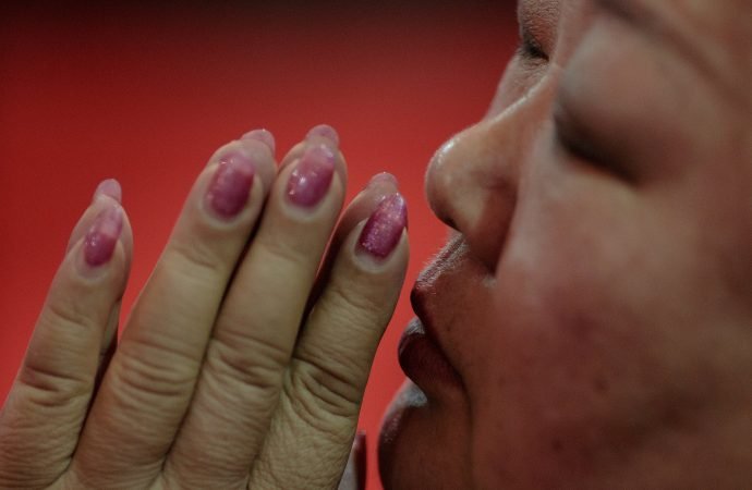 A woman prays during Holy Thursday Mass March 29, 2018, at the Cathedral of the Immaculate Conception in Beijing. (Damir Sagolj/Reuters via CNS)