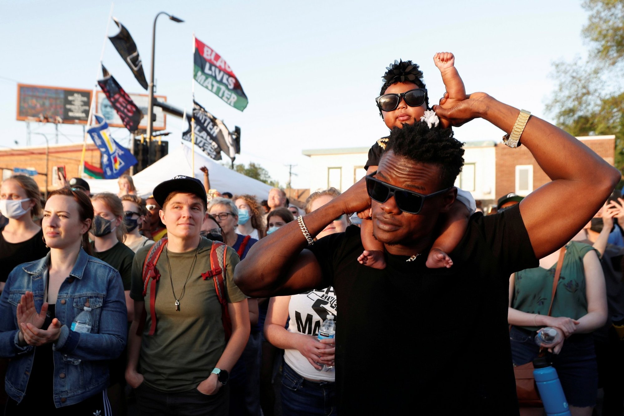 People at George Floyd Square in Minneapolis listen to live music during a Celebration of Life festival in honor of George Floyd March 25, 2021. (CNS photo/Eric Miller, Reuters)