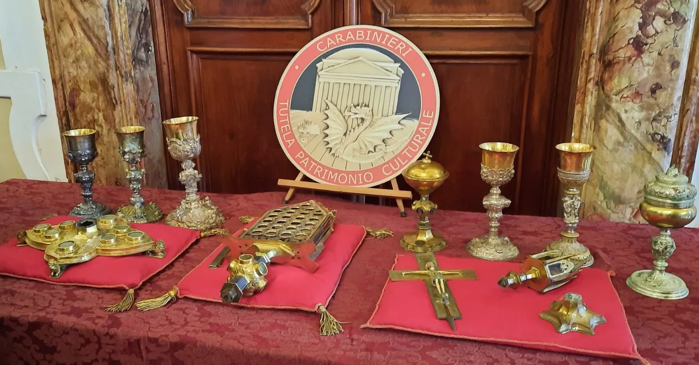 The reliquary with accompanying objects, including a copper cross and six silver chalices. (Courtesy of the Carabinieri Tutela Patrimonio Culturale in Palermo)