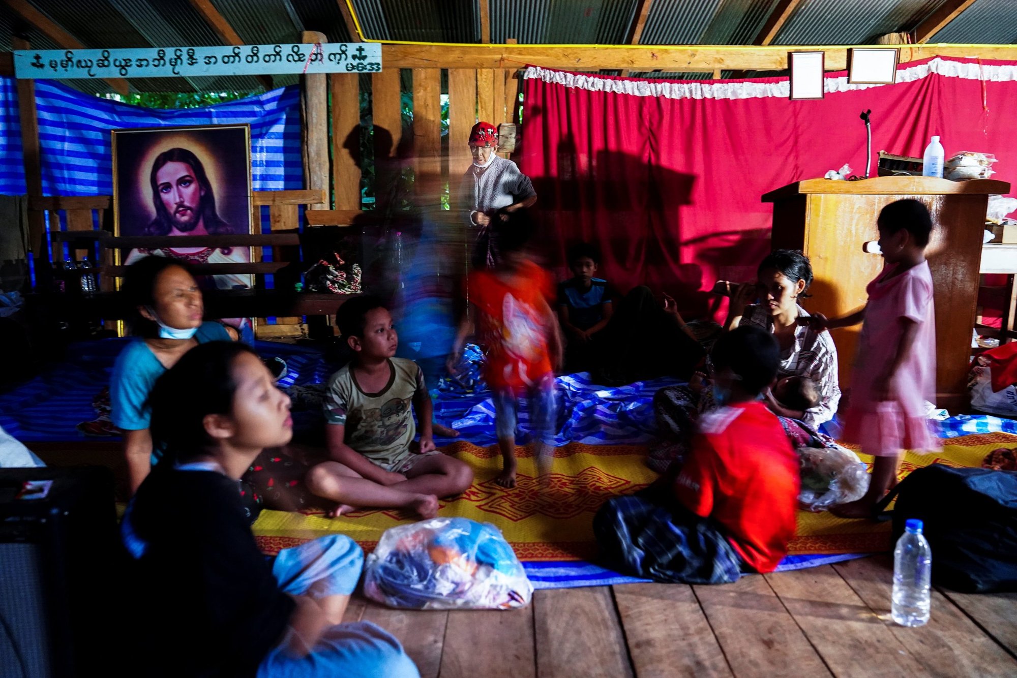 Villagers who fled after insurgents attacked a Myanmar army post sit at a school in the Thai border village of Mae Sam Laep, Mae Hong Son province, Thailand, on April 27. (CNS photo/Athit Perawongmetha, Reuters)