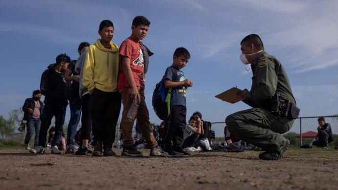 Anderson, a 6-year-old unaccompanied minor from El Salvador, stands in line with other asylum-seeking children in La Joya, Texas, May 14, 2021, as they identify themselves to a Border Patrol agent after crossing the Rio Grande from Mexico. (Adrees Latif/Reuters, CNS via Crux)