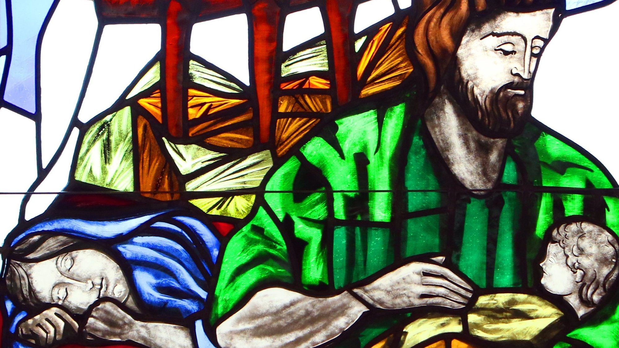 A depiction of St. Joseph cradling the infant Jesus while Mary sleeps is seen in a stained-glass window at St. Patrick Church in Smithtown, N.Y. (CNS photo/Gregory A. Shemitz)