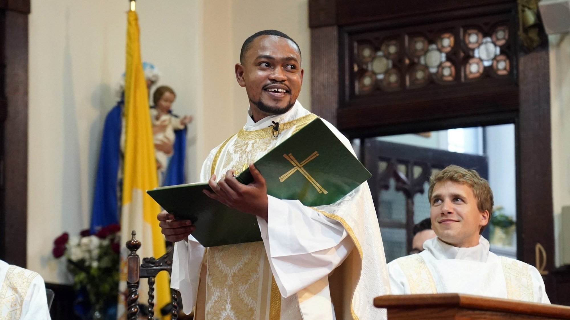 Father Wesbee Victor smiles as he celebrates his first Mass as a priest May 29, 2021, at St. Catherine of Genoa Church in New York City. Born in Port-au-Prince, Haiti, Father Victor, 31, was one of 10 men ordained to the priesthood by New York Cardinal Timothy M. Dolan at St. Patrick's Cathedral earlier in the day. (CNS photo/Gregory A. Shemitz)