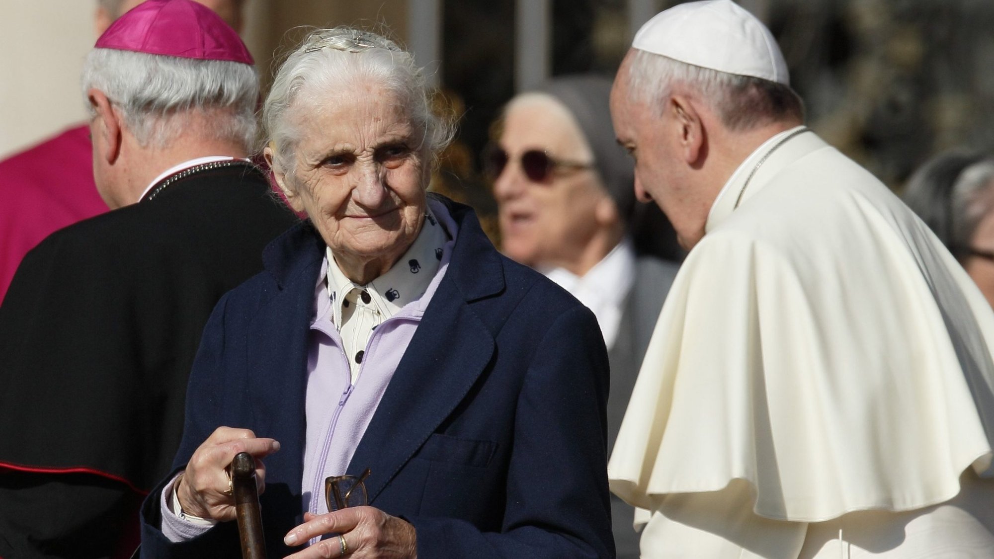 An elderly woman walks away after meeting Pope Francis in St. Peter's Square at the Vatican in this Sept. 28, 2014, file photo. The pope has chosen the theme "I am with you always," for the first World Day for Grandparents and the Elderly, to be celebrated July 25. (CNS photo/Paul Haring)
