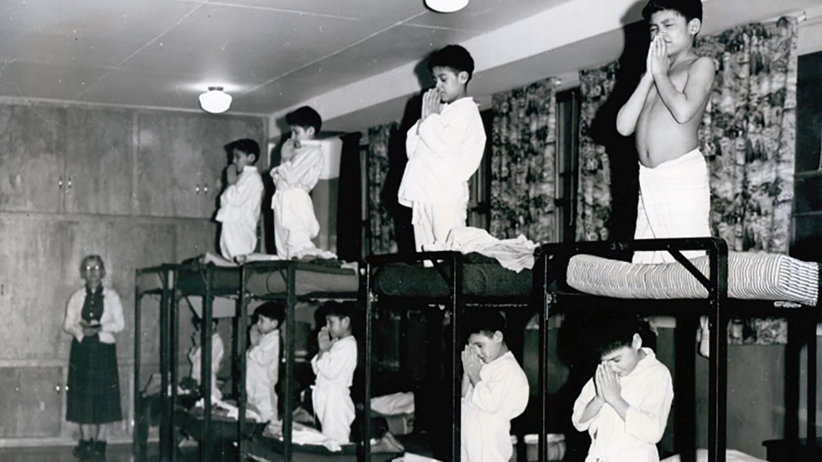 Indigenous boys pray on bunk beds in a dormitory at the Bishop Horden Memorial School, a residential school in the indigenous Cree community of Moose Factory, Ontario, in 1950. Recent confirmation of hundreds of unmarked graves on the grounds of two former residential schools for Indigenous children in Canada has prompted a U.S. Department of the Interior inquiry into U.S. boarding schools for Native Americans, which were often run by churches. (CNS photo/Shingwauk Residential Schools Centre, Handout via Reuters)