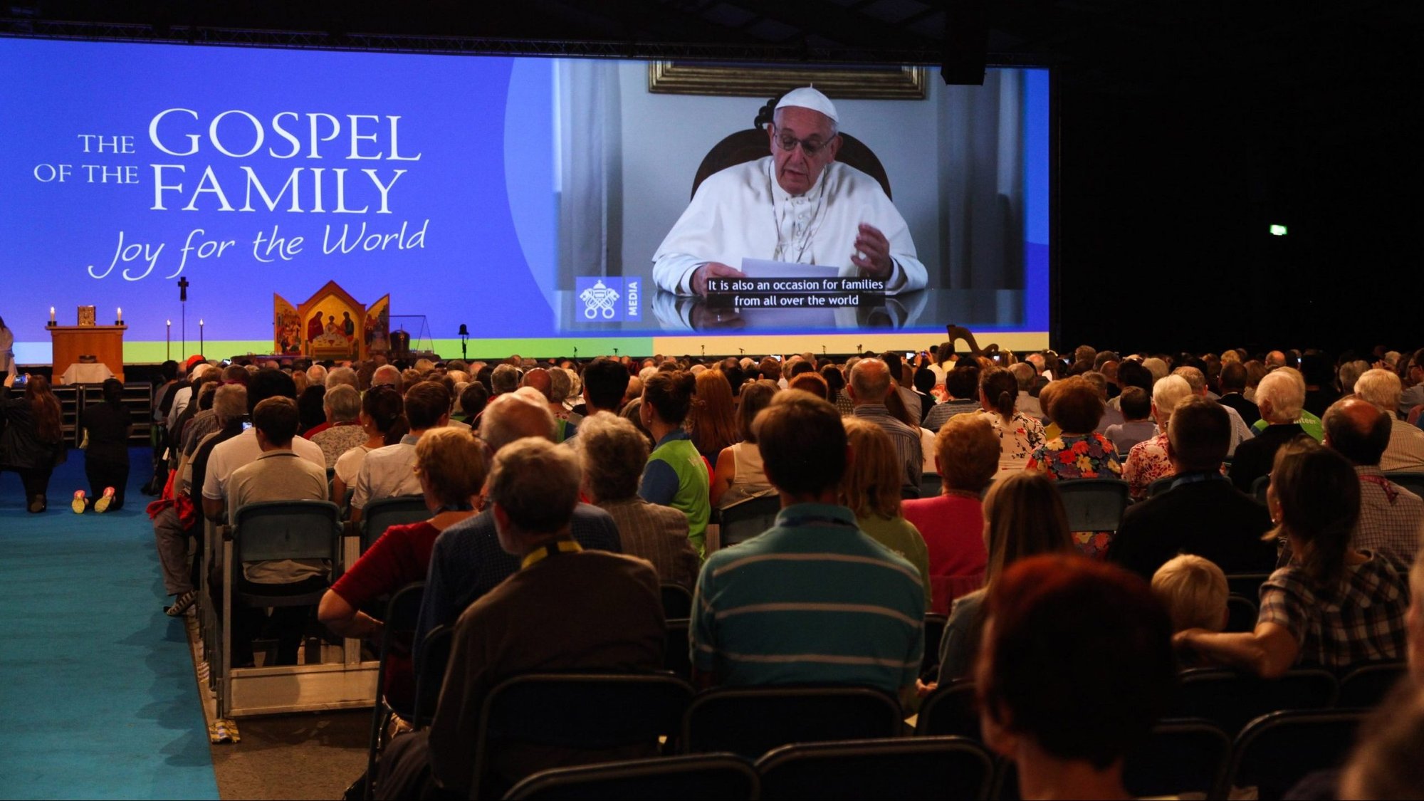 Attendees watch Pope Francis on a screen during the opening ceremony of the World Meeting of Families in Dublin Aug. 21, 2018. (CNS photo/John McElroy, courtesy World Meeting of Families)