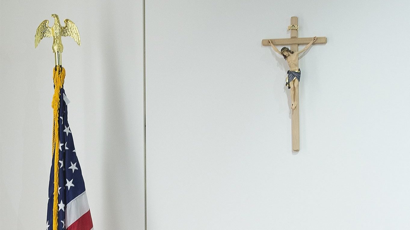 A cross and a U.S. flag are seen in this illustration photo. The 7th U.S. Circuit Court of Appeals July 9, 2021, dismissed a hostile work environment lawsuit brought against the Archdiocese of Chicago by a former parish music director. (CNS photo/Tyler Orsburn)