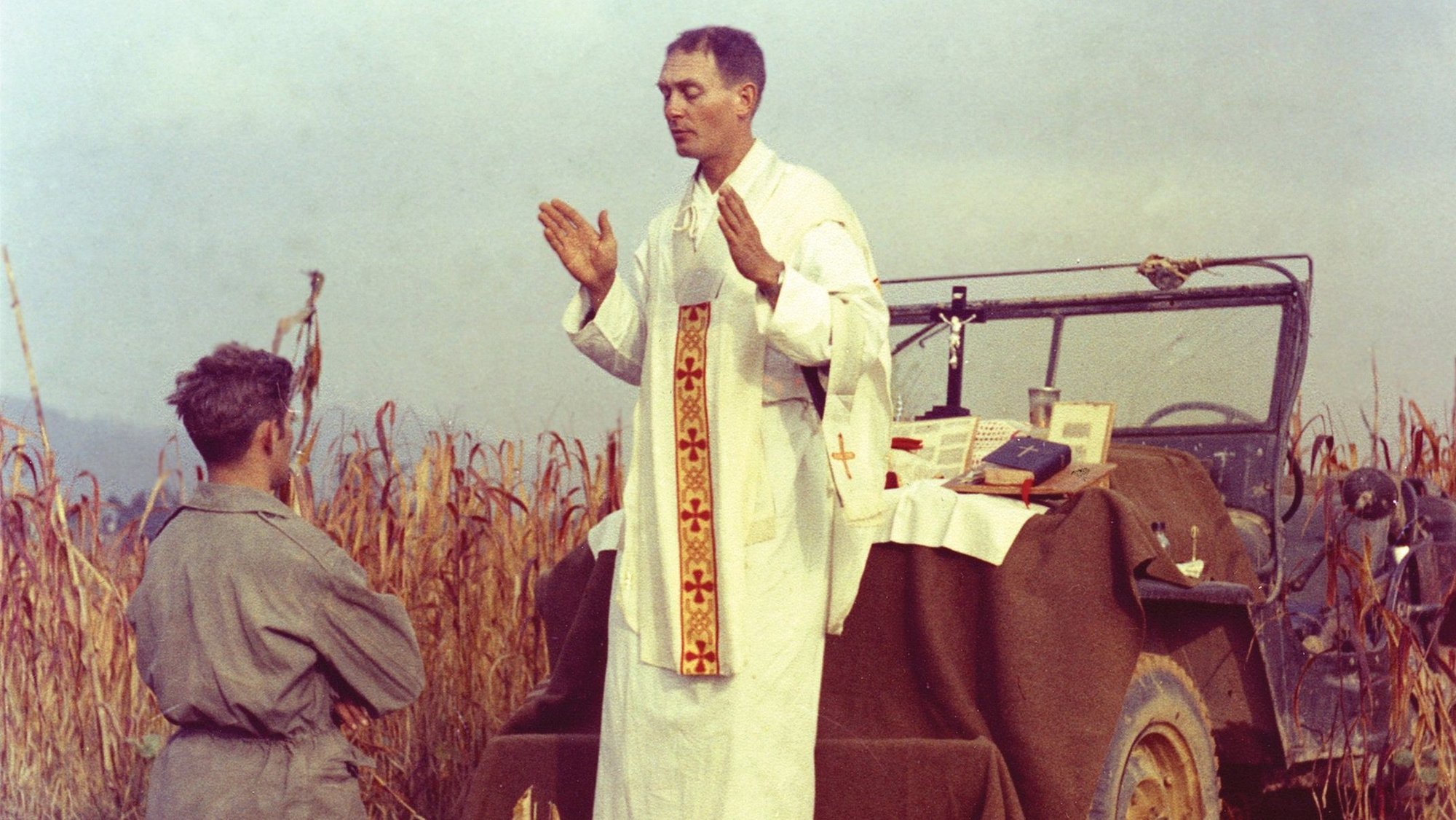 Father Emil Joseph Kapaun, a U.S. Army chaplain, is pictured celebrating Mass from the hood of a jeep Oct. 7, 1950, in South Korea. A candidate for sainthood, he died May 23, 1951, in a North Korean prisoner of war camp. (CNS photo/courtesy U.S. Army medic Raymond Skeehan)