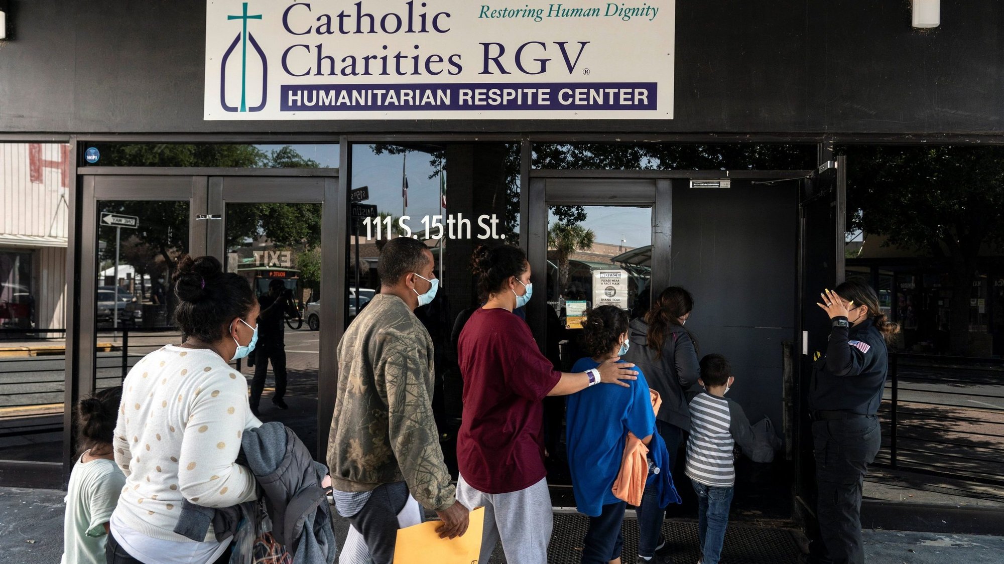 Migrants seeking asylum in the U.S. walk into a temporary humanitarian respite center run by Catholic Charities of the Rio Grande Valley in McAllen, Texas, April 8, 2021. (CNS photo/Go Nakamura, Reuters)