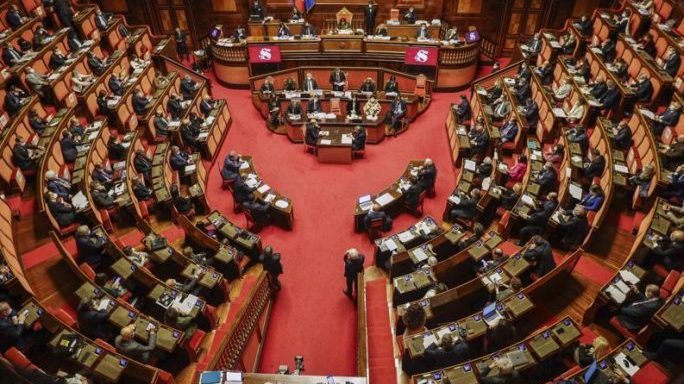 In this Tuesday, April 27, 2021 file photo, Italian Premier Minister Mario Draghi addresses the Senate in Rome. The Italian Senate has approved lowering the age of citizens eligible to vote for Parliament's upper chamber from 25 to 18. (AP Photo/Gregorio Borgia, Pool via Crux)