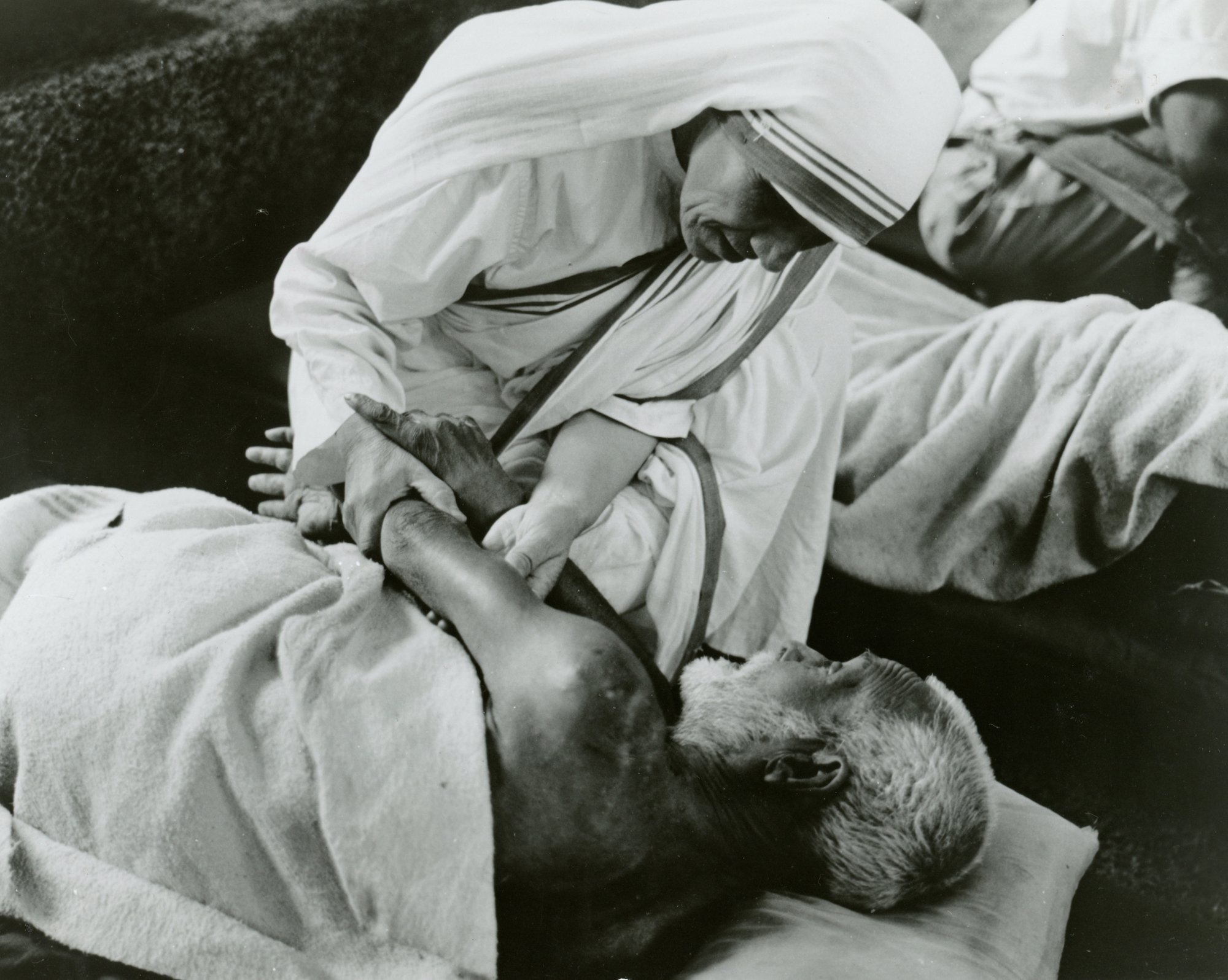 St. Teresa of Calcutta cares for a sick man in an undated photo. (CNS/KNA)