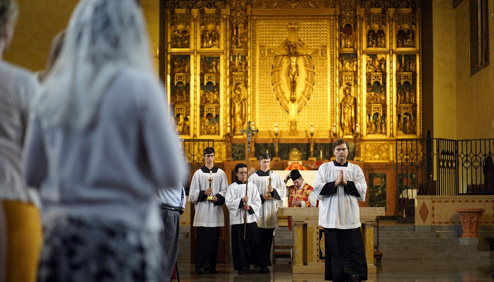 Altar server Bradley Morley leads the closing procession during a traditional Latin Mass July 1 at Immaculate Conception Seminary in Huntington, New York. (CNS/Gregory A. Shemitz)