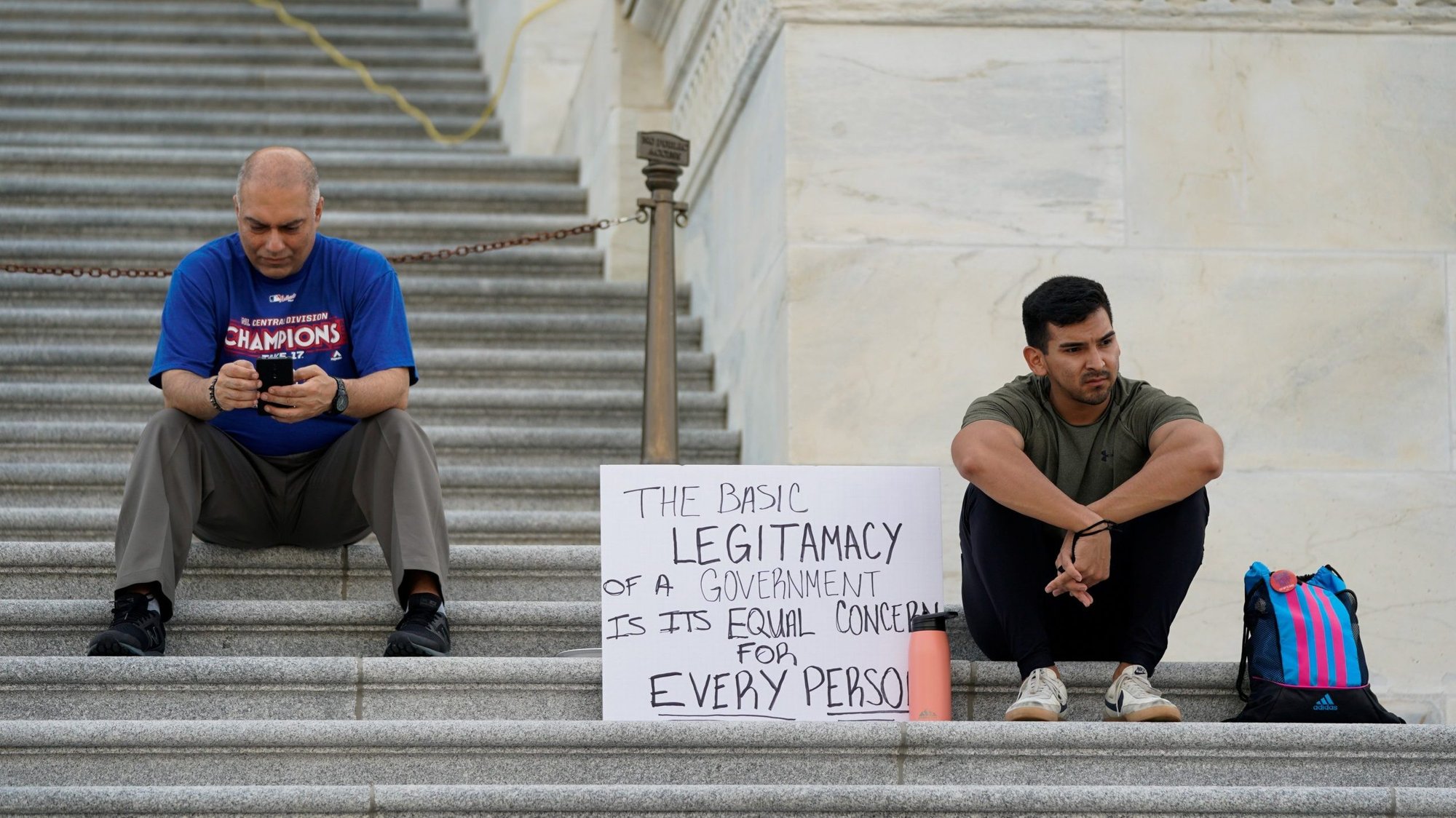 Two people sit on the steps of the U.S. Capitol in Washington Aug. 1, 2021, during a multiday protest supporting an extension of the pandemic-related federal moratorium on residential evictions, which expired at midnight July 31. President Joe Biden issued a new moratorium on evictions by executive order Aug. 3. (CNS photo/Elizabeth Frantz, Reuters)