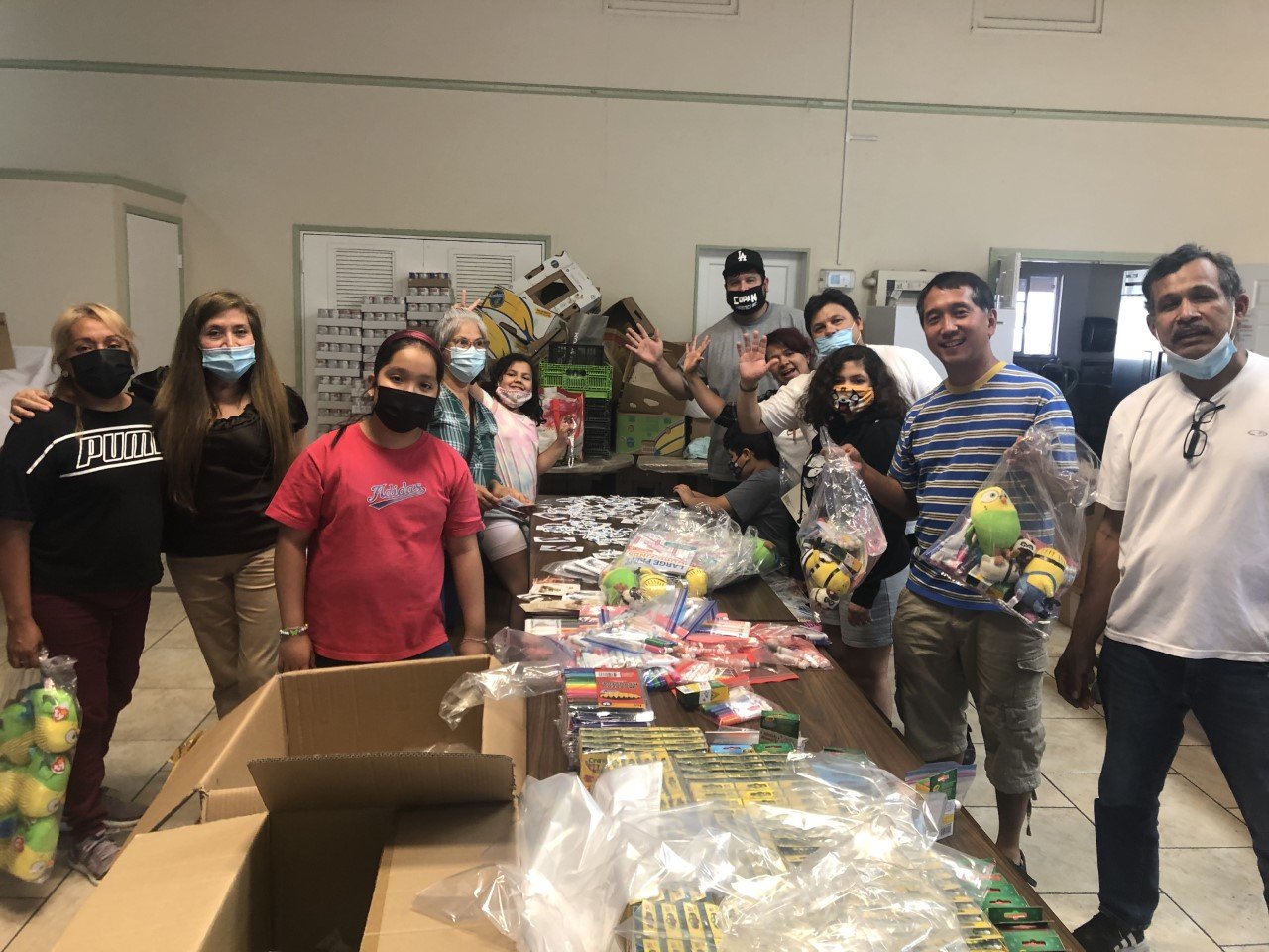 Volunteers at St. Lucy Church in Long Beach pack gift bags for the migrant kids at the federal emergency center. (Submitted photo)