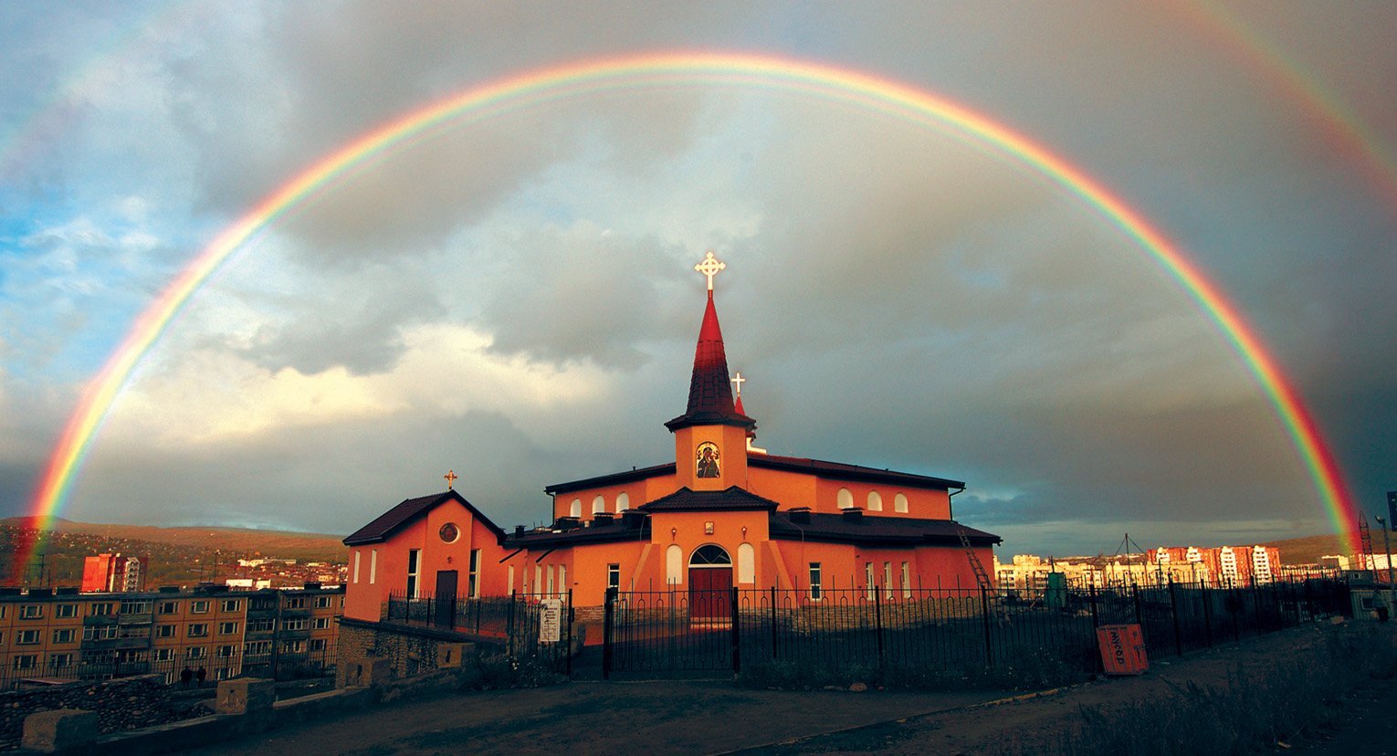 A rainbow forms a perfect arc over the Church of the Nativity of Jesus in Magadan, Russia, in 2004. Nativity of Jesus is the first and only Catholic church built in this city on the east coast of Russia. (CNS/Father Janez Sever, SJ)
