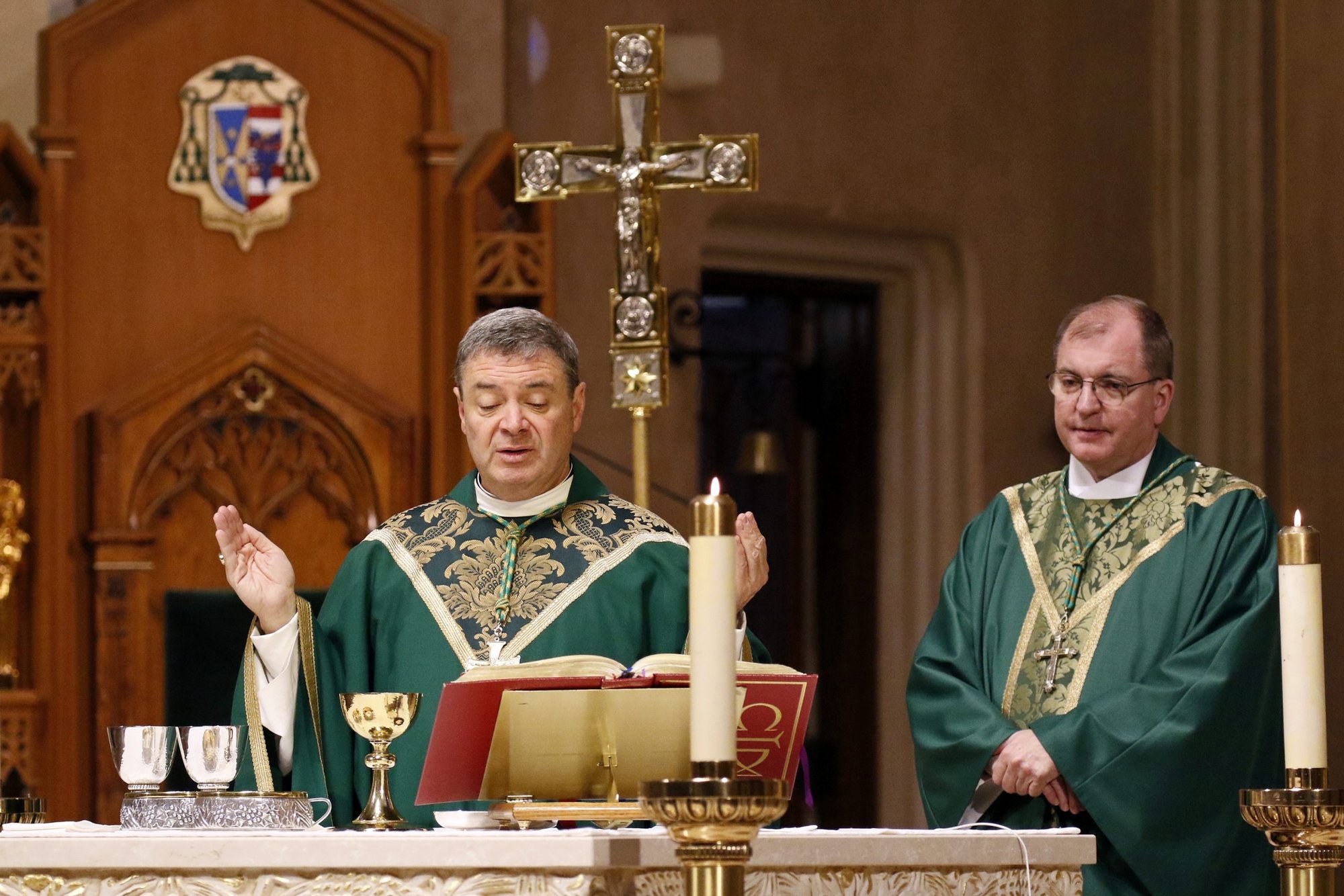 Bishop Robert J. Brennan, left, concelebrates Mass at St. Agnes Cathedral in Rockville Centre, N.Y., Feb. 1, 2019, a day after he was named to head the Diocese of Columbus, Ohio. Also pictured is Bishop John O. Barres of Rockville Centre. (CNS photo/Gregory A. Shemitz)