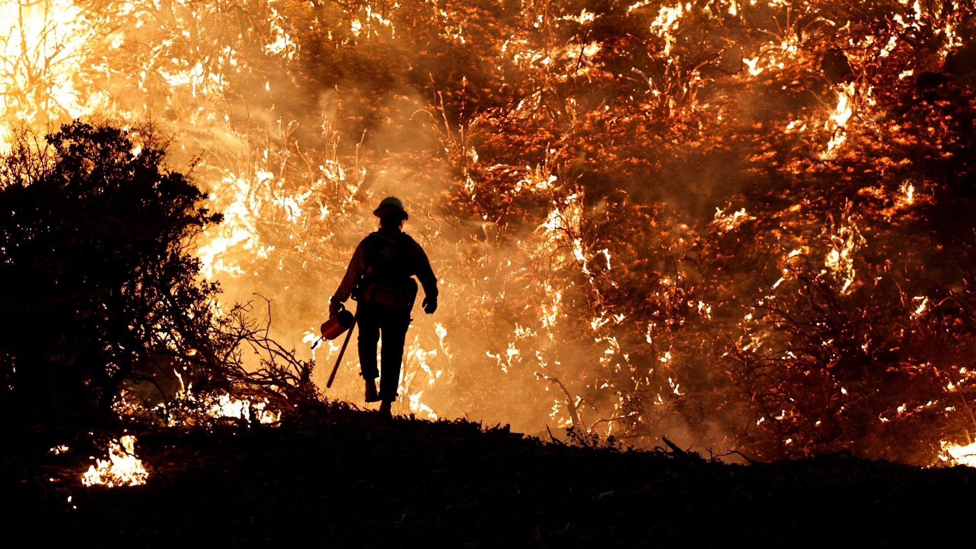 A firefighter in Grizzly Flats, Calif., works the Caldor Fire Aug. 22, 2021. (CNS photo/Fred Greaves, Reuters)