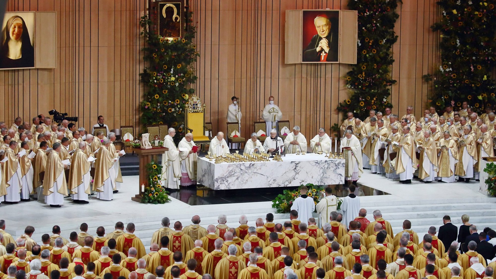 Members of the clergy pray during the beatification ceremony of Cardinal Stefan Wyszynski and Mother Elisabeth Rosa Czacka in the Church of Divine Providence in Warsaw, Poland, Sept. 12, 2021. (CNS photo/Grzegorz Galazka)