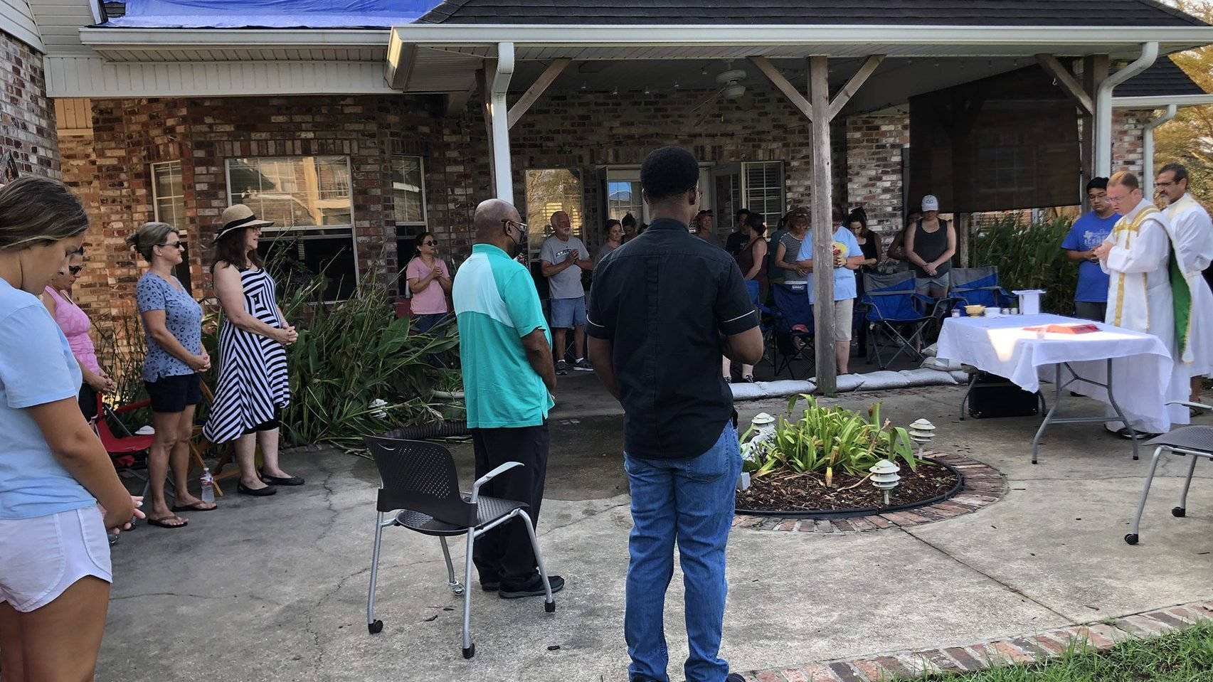 Father David Ducote, pastor at St. Joan of Arc Catholic Parish in LaPlace, La., celebrates an outdoor Mass Sept. 9, 2021, at the home of Adam and Michelle Williams for approximately 35 storm-weary Catholics who needed a respite from cleaning up their homes from Hurricane Ida damage. (CNS photo/Christine Bordelon, Clarion Herald)