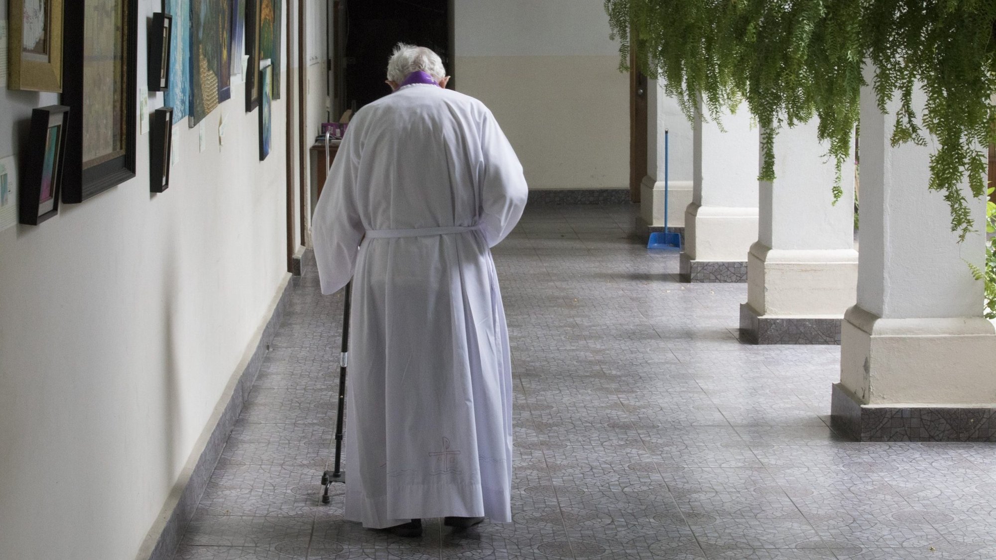 An elderly priest is pictured in a file photo walking to his residence at Our Lady of Carmen Church in Panama City. Getting old isn't a disease, it's a privilege, Pope Francis told older priests in a written message. (CNS photo/Bob Roller)