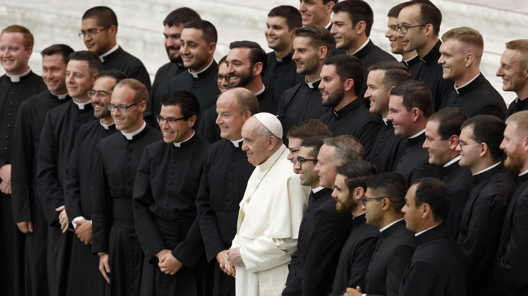 Pope Francis poses for a photo with seminarians from the Pontifical North American College during his general audience in the Paul VI hall at the Vatican Sept. 29, 2021. Standing next to the pope is Father Peter Harman, rector of the U.S. seminary. (CNS photo/Paul Haring)