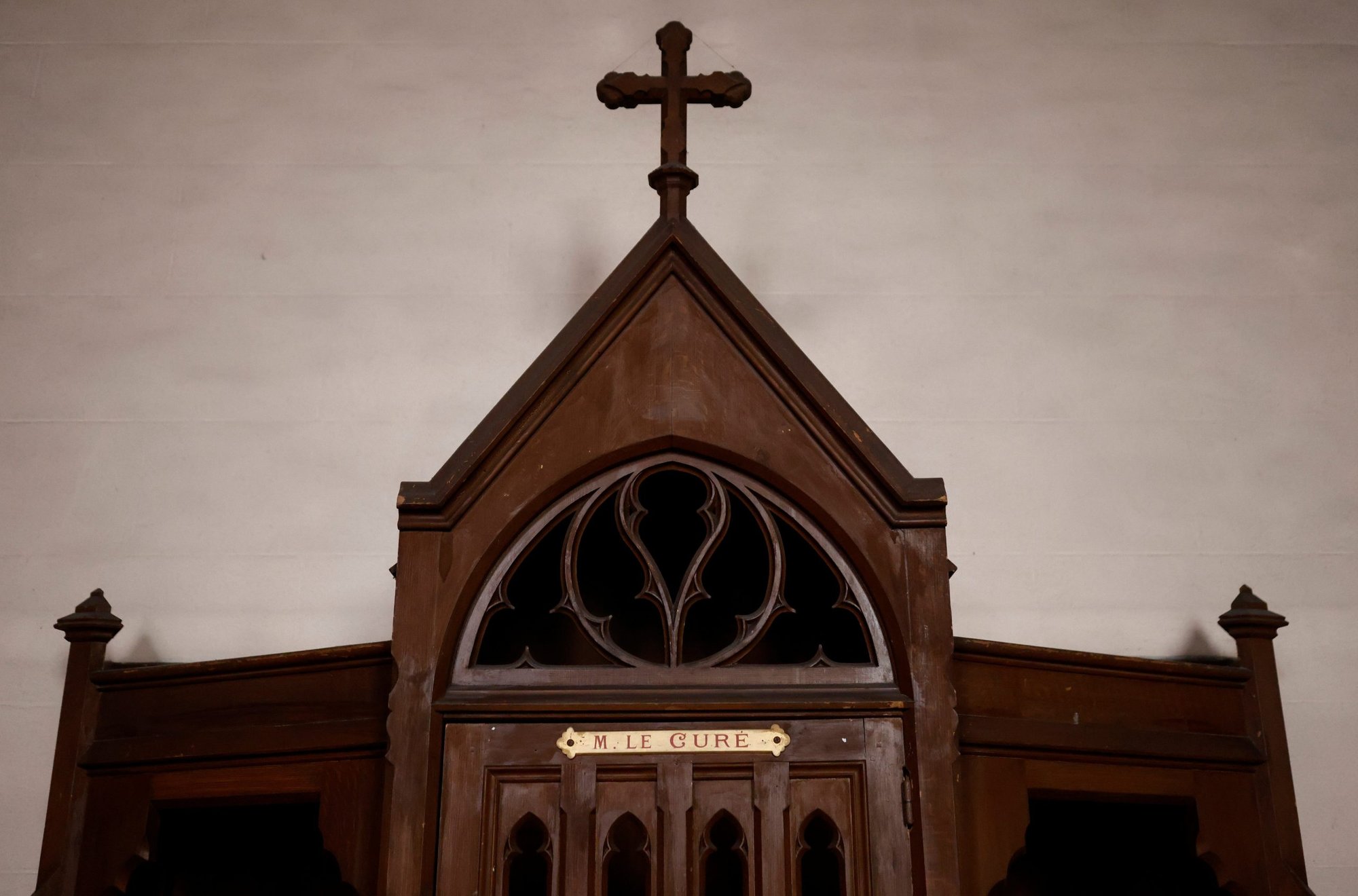 A confessional on which is written: "M. the Priest" is pictured in a Catholic church near Nantes, France, Oct. 5, 2021. Church and government leaders in France are at odds over whether priests should be required to report the abuse of minors if they learn about it in the sacrament of confession. (CNS photo/Stephane Mahe, Reuters)
