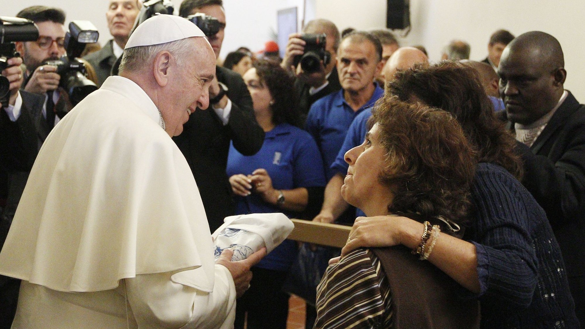 Pope Francis greets people during a meeting with the poor in the archbishop's residence in Assisi, Italy, in this Oct. 4, 2013, file photo. The pope will travel to Assisi Nov. 12 for a time of listening and prayer with 500 poor people from several countries. (CNS photo/Paul Haring)