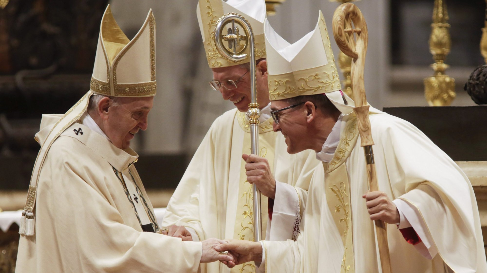Pope Francis greets newly ordained Bishop Guido Marini, former master of liturgical ceremonies, and Archbishop Andrés Gabriel Ferrada Moreira, the secretary of the Congregation for Clergy, during an episcopal ordination Mass in St. Peter's Basilica at the Vatican Oct. 17, 2021. (CNS photo/Romano Siciliani, pool)