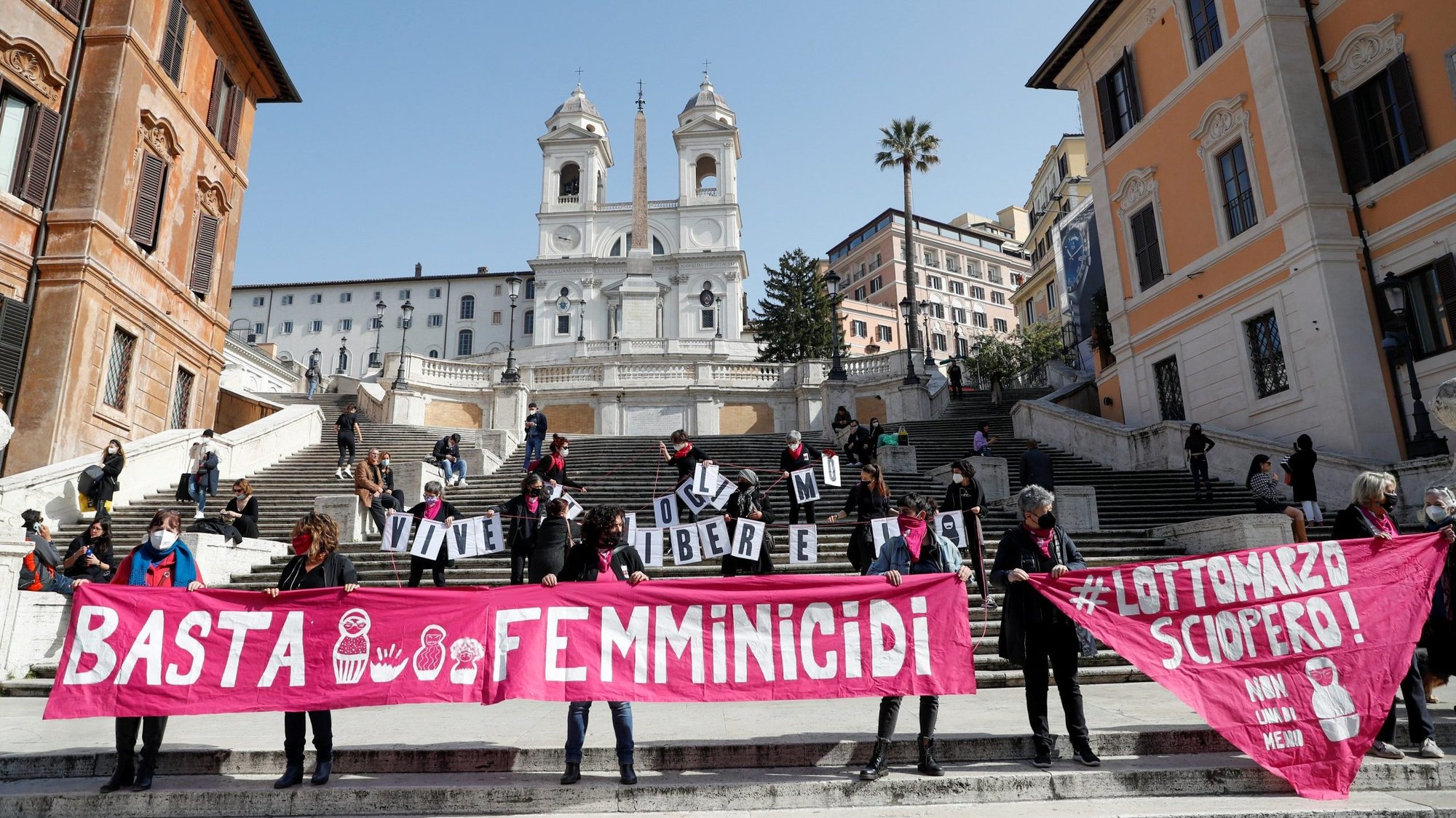 Activists protest at Rome's Spanish Steps Feb. 26, 2021, ahead of International Women's Day March 8. The protesters were calling for the elimination of violence against women and demanding more government aid for those struggling financially because of the COVID-19 pandemic. (CNS photo/Yara Nardi, Reuters)