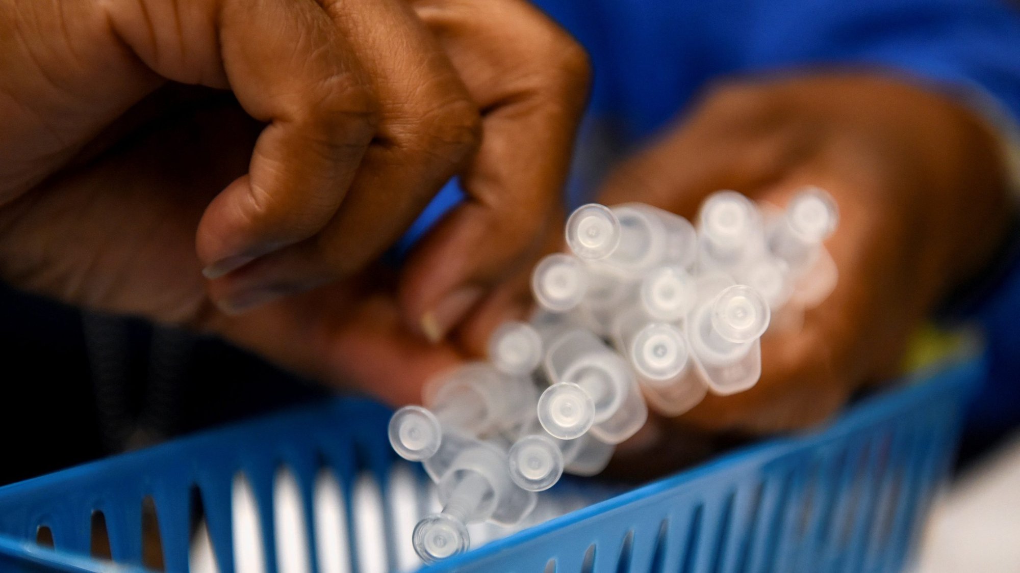 A health care worker prepares doses of the coronavirus disease vaccine Oct. 13, 2021. (CNS photo/Callaghan O'Hare, Reuters)