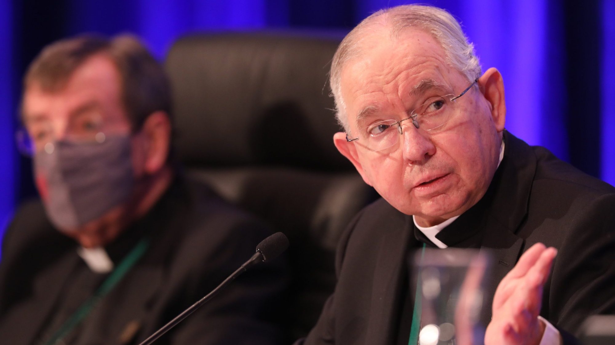 Archbishop José H. Gomez of Los Angeles, president of the U.S. Conference of Catholic Bishops, gestures alongside Detroit Archbishop Allen H. Vigneron, vice president, during a Nov. 17, 2021, session of the bishops' fall general assembly in Baltimore. Due to the COVID-19 pandemic, it is the first in-person bishops' meeting since 2019. (CNS photo/Bob Roller)
