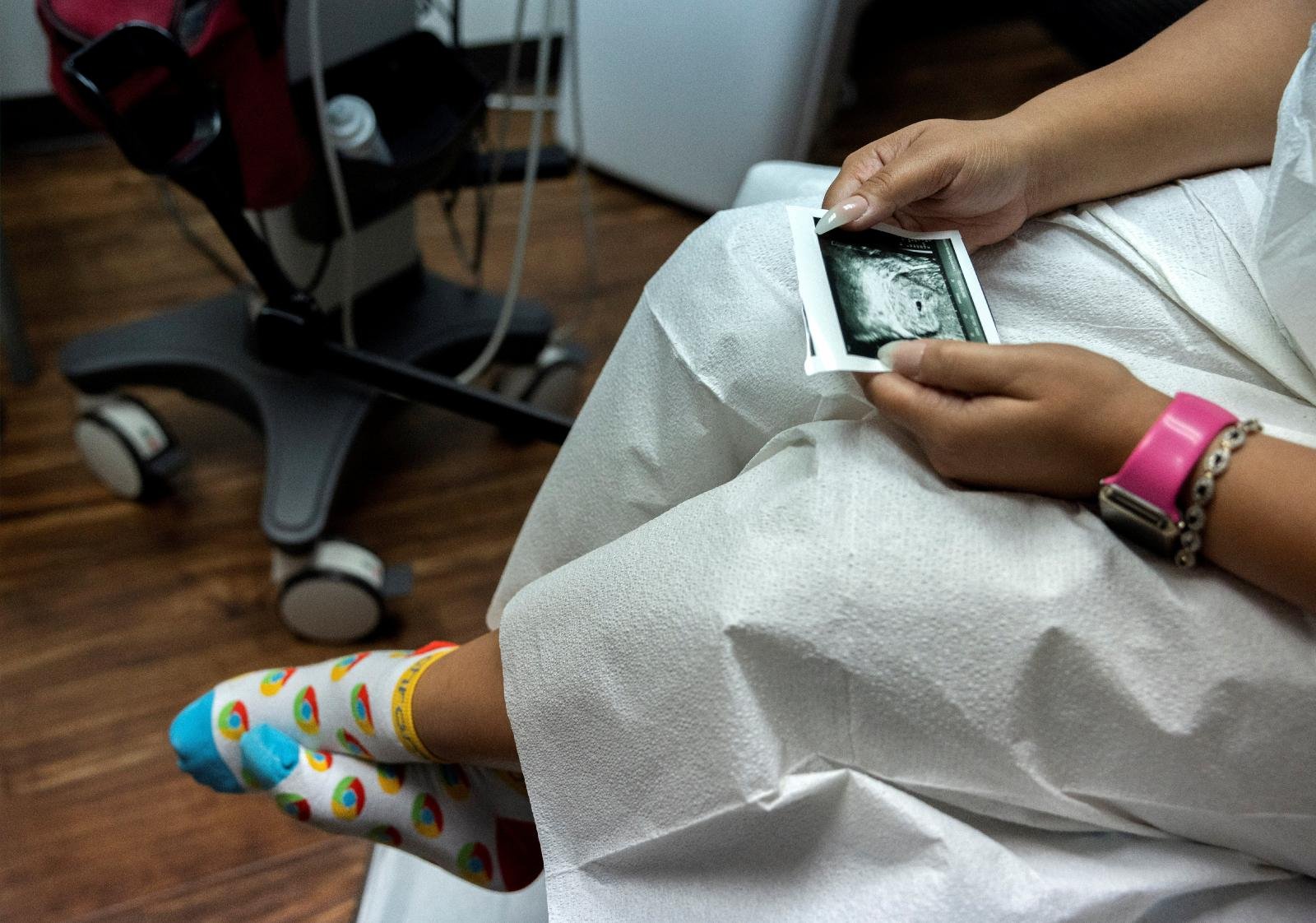 A woman in Houston looks at a picture of her ultrasound at Houston Women's Reproductive Services Oct. 1, 2021. (CNS photo/Evelyn Hockstein, Reuters)