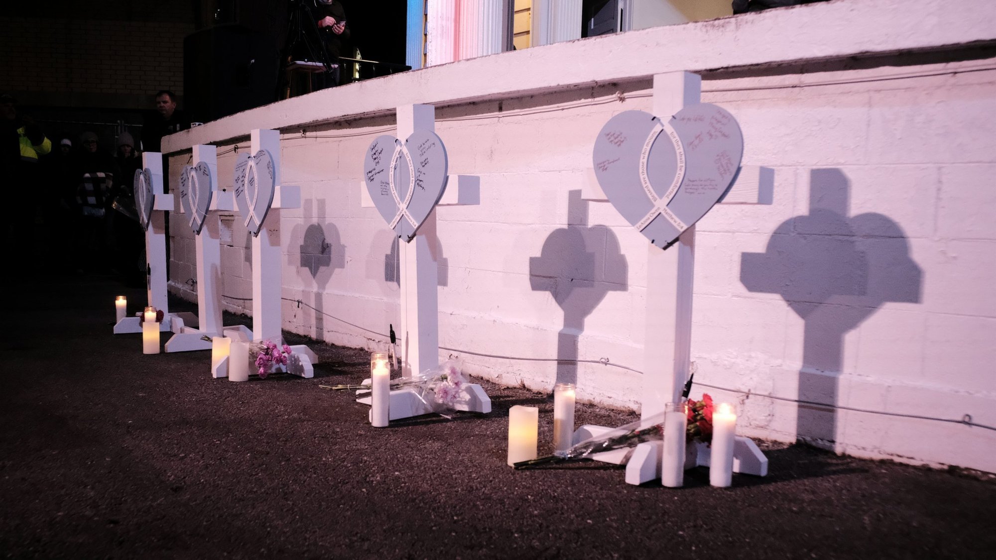 Markers for five victims are seen as Kenosha residents attend a candlelight vigil in Waukesha, Wis., Nov. 22, 2021, the day after a car plowed through a Christmas parade in the city. Pope Francis sent his condolences to the victims and families of the attack. (CNS photo/Daniel Steinle, Reuters)