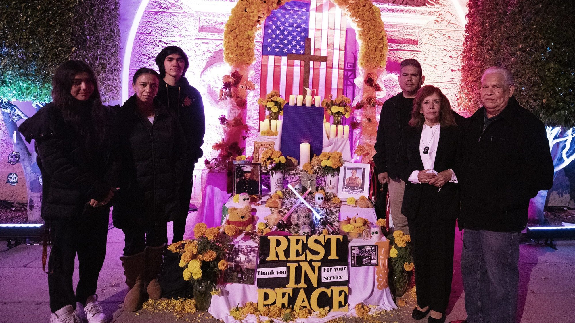 From left to right, Cpl. Hunter Lopez’s cousins and his aunt, Myrna, uncle Juan Carlos Lopez and grandparents Carlos and Helen Lopez, stand at the traditional “Dia de los Muertos” prayer altar built in Lopez’s memory at Calvary Cemetery in East LA. Lopez was killed Aug. 26 in Kabul during the US withdrawal from Afghanistan. (Victor Alemán)