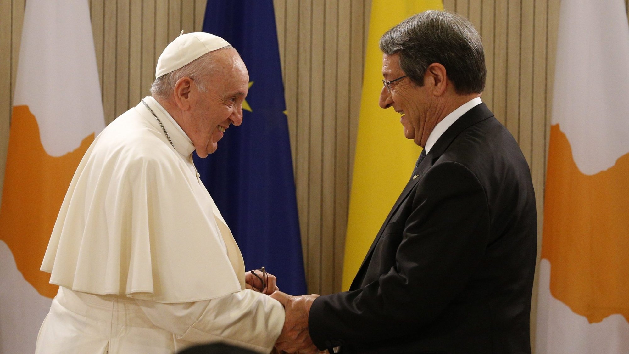 Pope Francis is greeted by Cypriot President Nicos Anastasiades as he arrives for a meeting with government authorities, civic leaders and members of the diplomatic corps in the Ceremonial Hall of the presidential palace in Nicosia, Cyprus, Dec. 2, 2021. (CNS photo/Paul Haring)