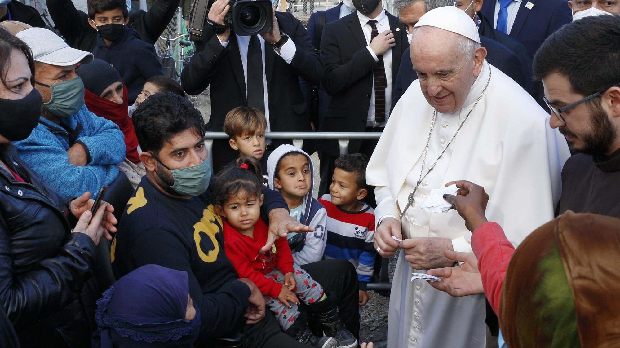 Pope Francis receives notes as he visits with refugees at the government-run Reception and Identification Center in Mytilene, Greece, Dec. 5, 2021. (CNS photo/Paul Haring)
