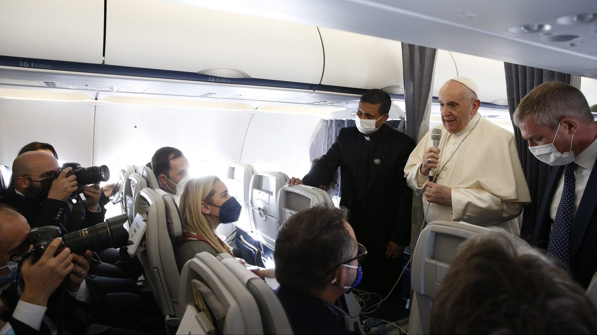 Pope Francis answers questions from journalists aboard his flight from Athens, Greece, to Rome Dec. 6, 2021. The pope was concluding a five-day visit to Cyprus and Greece. (CNS photo/Paul Haring)