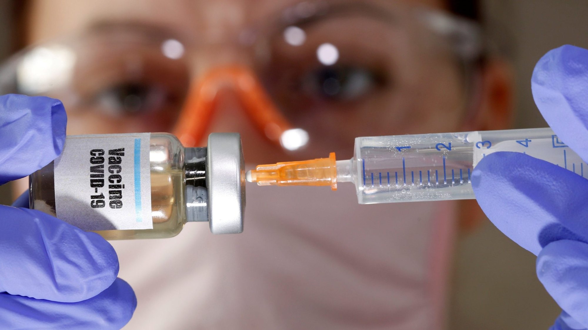 A woman holds a small bottle labeled "Vaccine COVID-19" in this illustration photo. (CNS photo/Dado Ruvic, Reuters)