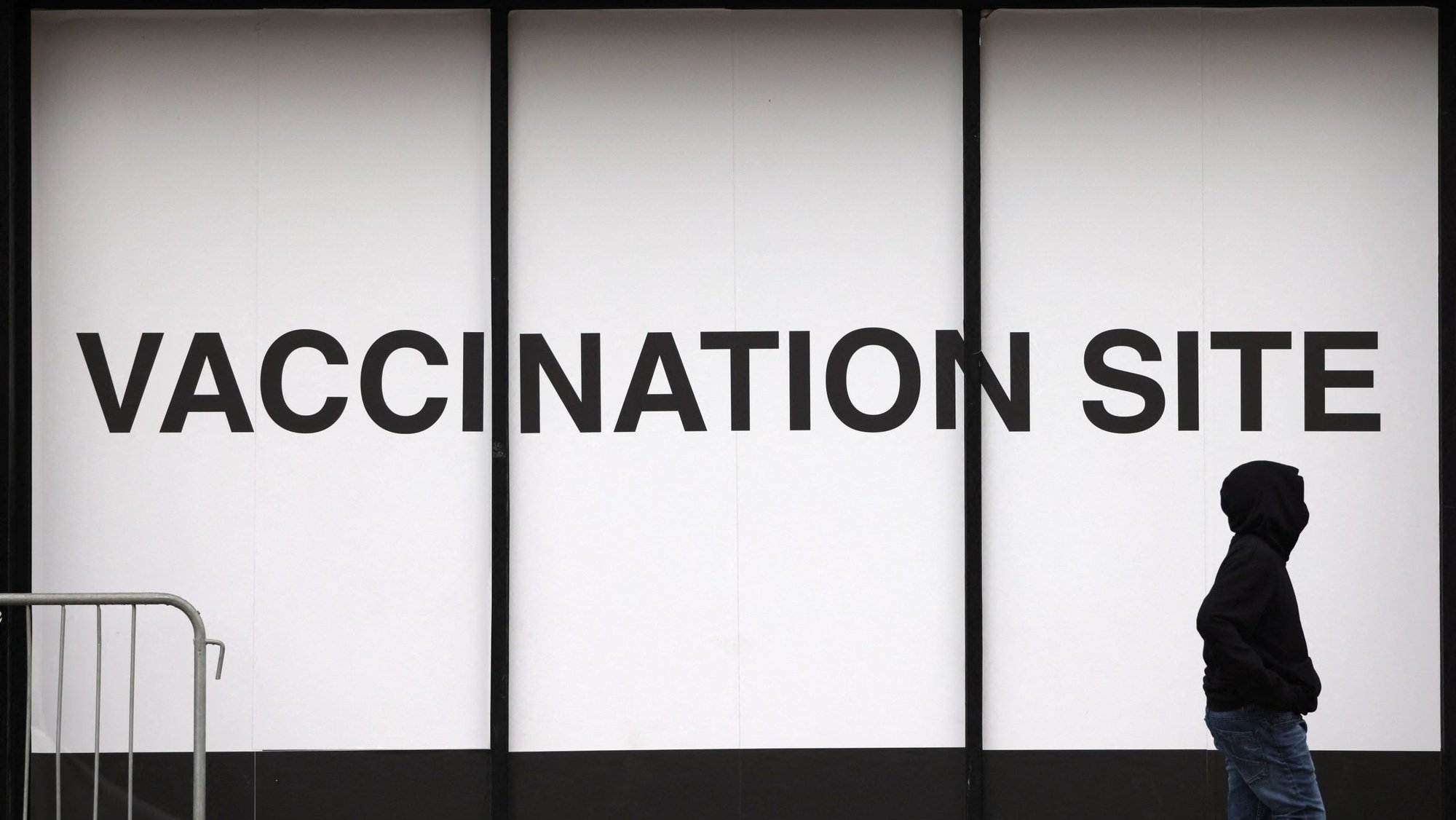 A person walks past a vaccination site in New York City Dec. 18, 2021. The federal Centers for Disease Control and Prevention reported Dec. 20 that the omicron variant is now the dominant version of the coronavirus in the United States. (CNS photo/Andrew Kelly, Reuters)