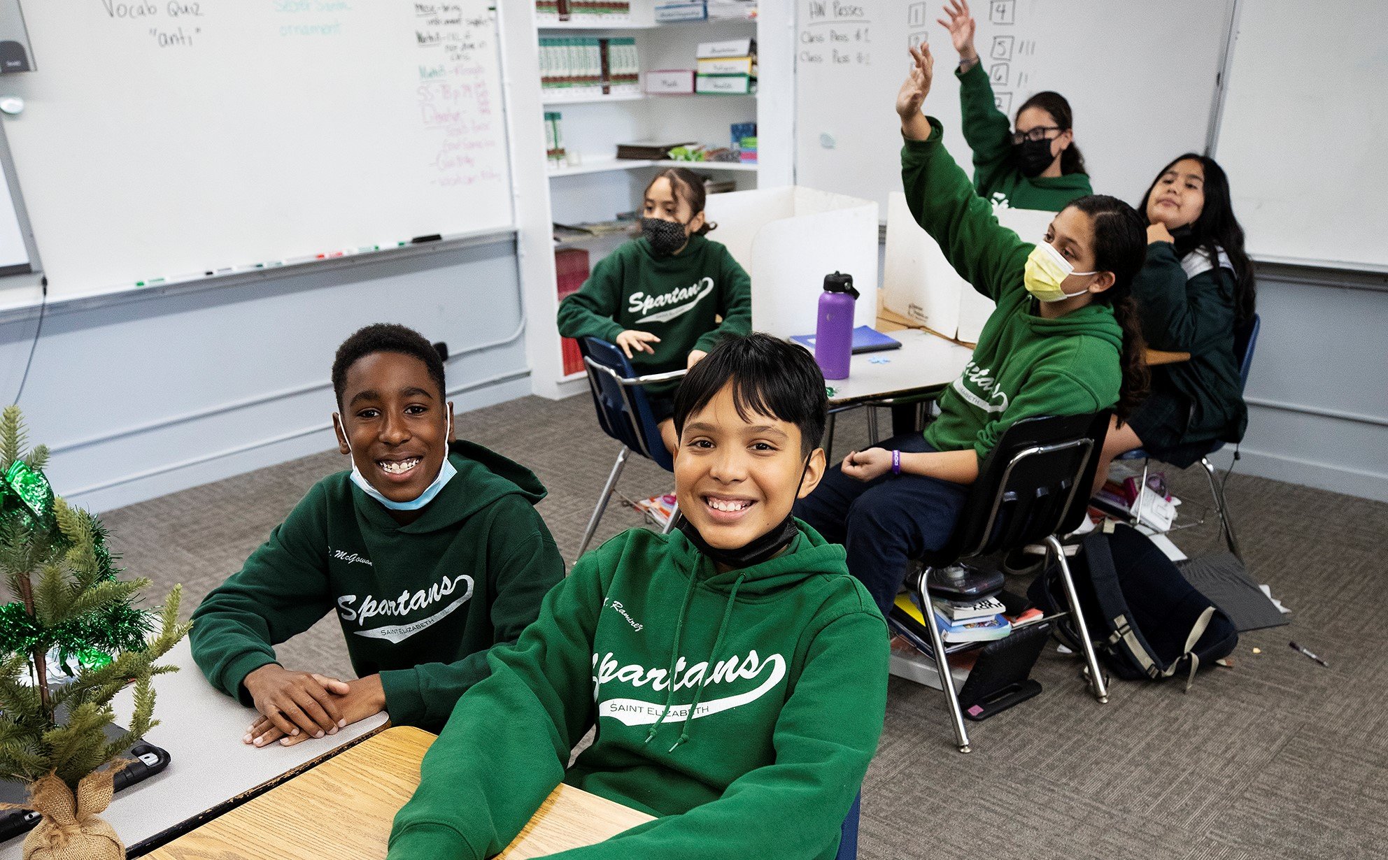 Sixth-grader Mario Ramirez (center) of St. Elizabeth of Hungary School in Altadena is back in the classroom after surviving several gunshot wounds from a shooting outside his home last February. At left is Ramirez's friend Dallas McGowan. (Victor Alemán)
