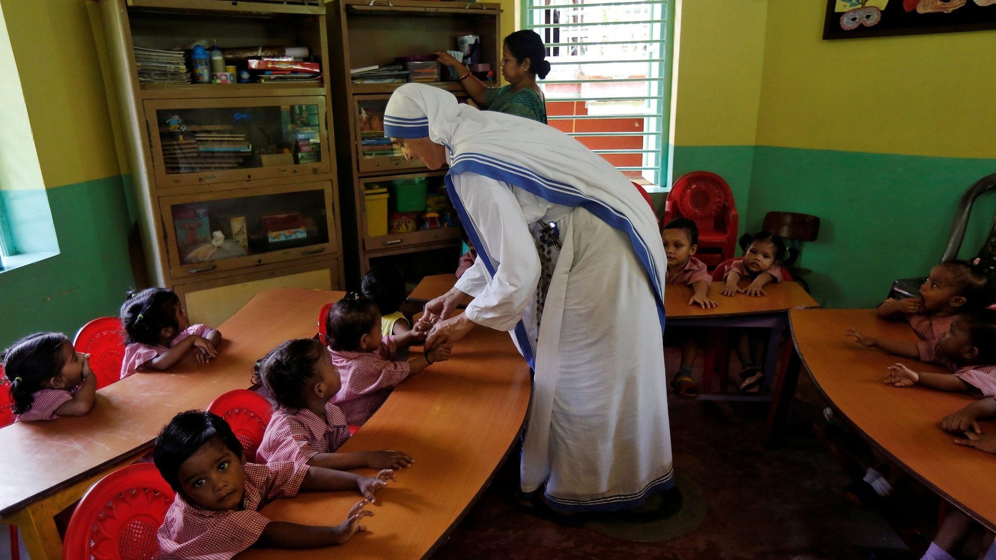 A member of the Missionaries of Charity interacts with the children of a kindergarten inside the Nirmala Shishu Bhavan, a home for orphaned, destitute and abandoned children in Kolkata, India, Aug. 30, 2016. The Indian government has restored the Foreign Contribution Regulation Act registration of the Missionaries of Charity, clearing the decks for the globally renowned charity to receive and utilize foreign funds. (CNS photo/Rupak De Chowdhuri, Reuters)
