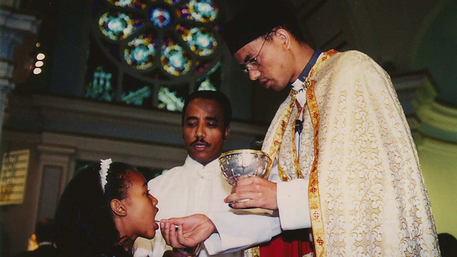 An Eritrean Catholic priest in California distributes Communion during a Divine Liturgy celebrated for Catholics from his homeland in this illustration photo. (CNS photo/Luis Gris, Catholic Voice)