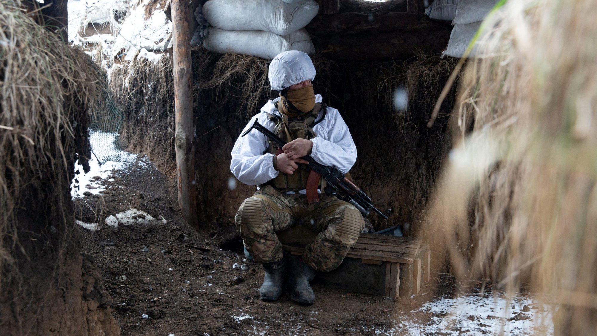 A service member of the Ukrainian armed forces is seen at combat positions at the line of separation from Russian-backed rebels near the village of Novomykhalivka in the Donetsk region, Ukraine, Jan. 21, 2022. Pope Francis at his Jan. 23 Sunday Angelus said he is deeply concerned by growing tensions between Russia and Ukraine and called for a day of prayer for peace Jan. 26. (CNS photo/Anna Kudriavtseva, Reuters)