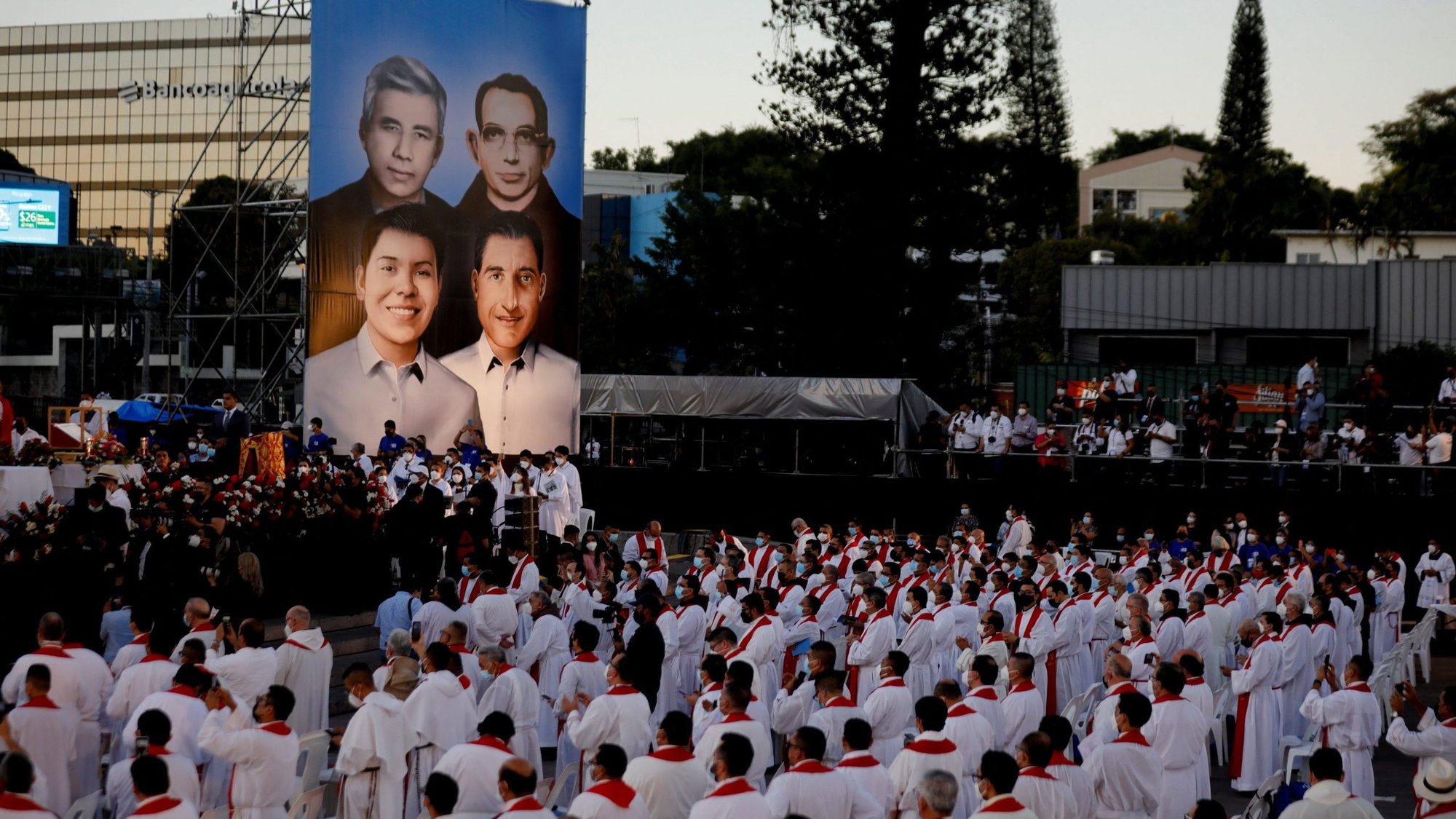 Images are displayed on a screen of Jesuit Father Rutilio Grande and Franciscan Father Cosme Spessotto, top row, and laymen Nelson Rutilio Lemus and Manuel Solórzano, during their beatification Mass in San Salvador, El Salvador, Jan. 22, 2022. (CNS photo/Jose Cabezas, Reuters)