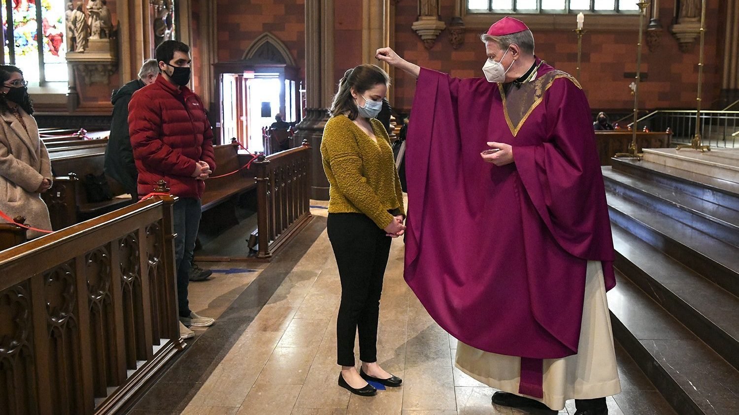 Bishop Edward B. Scharfenberger of Albany, N.Y., sprinkles ashes on parishioners during Mass at the Cathedral of the Immaculate Conception Feb. 17, 2021, amid the coronavirus pandemic. Lent 2022 begins March 2, which is Ash Wednesday. (CNS photo/Cindy Schultz, The Evangelist)