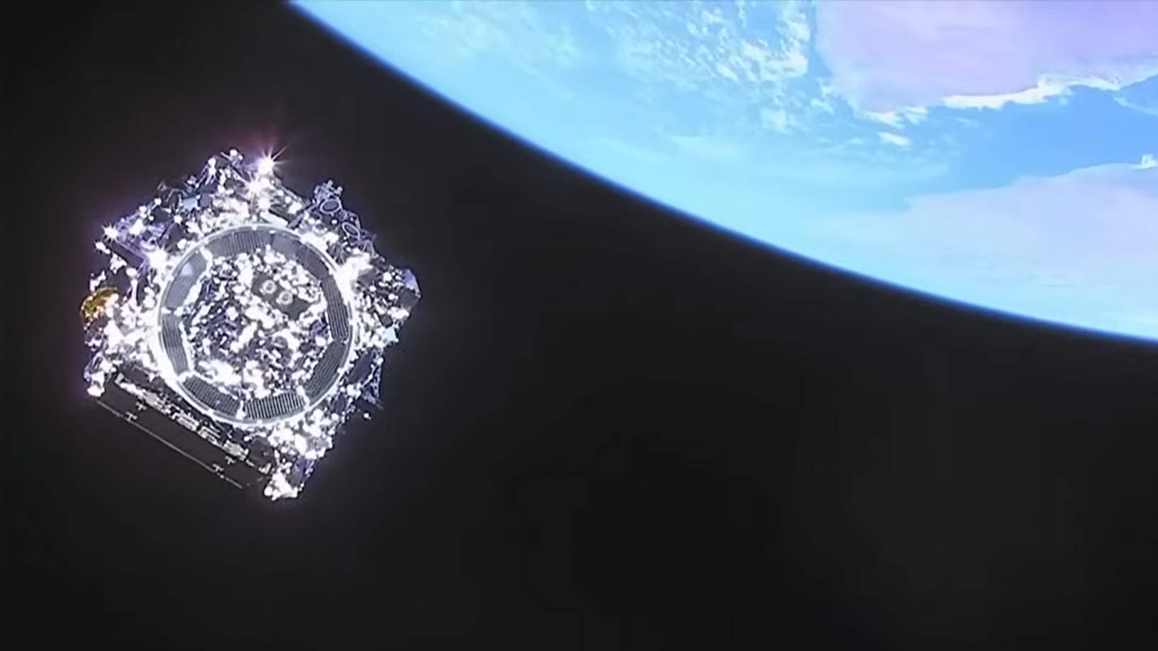 The James Webb Space Telescope seen approximately 29 minutes after launch. Part of the Earth with the Gulf of Aden can be seen in the background. (Screenshot via YouTube/NASA)